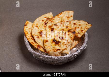 Indian cuisine Tandoori Roti also served in basket including chapati, flatbread, naan or nan bread on wooden background Stock Photo