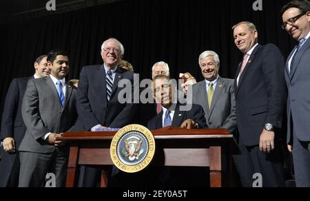 U S President Barack Obama C Is Surrounded By Lawmakers And Family Members Of Slain Police Officers As He Signs The Rafael Ramos And Wenjian Liu National Blue Alert Act Into Law In