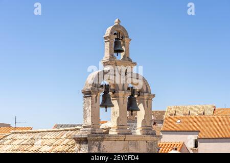 Three bronze bells on top vew from St. Ivana fort of Dubrovink old town city wall in Croatia summer Stock Photo