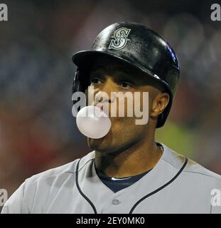 Seattle Mariners' Robinson Cano blows a bubble with his gum as he rounds  the bases after hitting a solo home run during the first inning of a  baseball game against the Cleveland