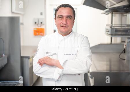 Baiersbronn, Germany. 05th Mar, 2021. Torsten Michel, chef de cuisine of the Schwarzwaldstube, stands in the interim restaurant 'temporaire - Schwarzwaldstube' of the Traube Tonbach after the digital awarding of the Michelin stars. The restaurants got their stars back, which they had lost after a fire in January 2020 in the parent house. Credit: Sebastian Gollnow/dpa/Alamy Live News Stock Photo