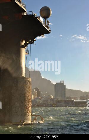 Cape Town harbour view with a drilling rig moored in front and Table Mountain in the background Stock Photo