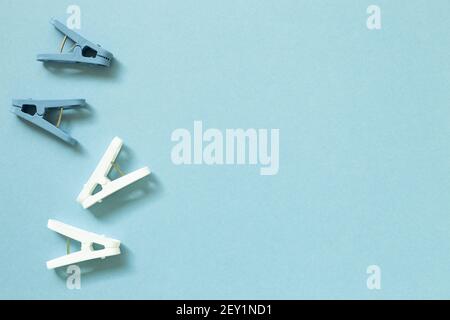 Laundry plastic clothespins on blue background. top view, copy space Stock Photo