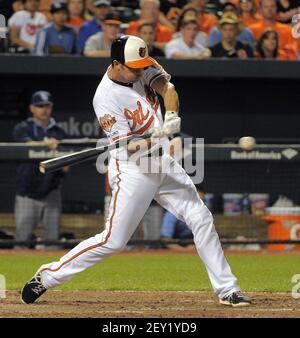 Baltimore Orioles' Nelson Cruz, left, celebrates with teammates J.J. Hardy  (2) and David Lough after Hardy and Lough scored on a double by Jimmy  Paredes in the 11th inning in the first