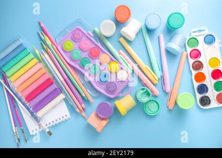 Online study and drawing, distantly painting class. Various colorful stationery and supplies for drawing. paints, pastels, pencils, brushes, tablet on Stock Photo