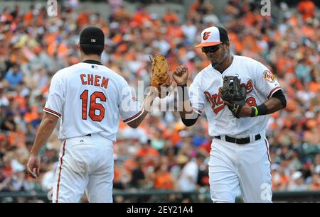 Baltimore Orioles third baseman Jimmy Paredes wipes pie from his face after  teammate Adam Jones threw a pie in his face in celebration after Paredes  hit the game winning RBI double in