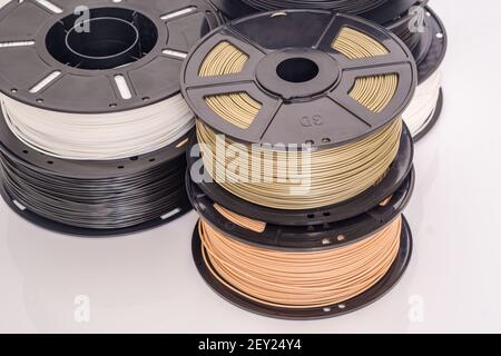 Many spools of plastic filament for 3D printer. Different colors. Stock Photo