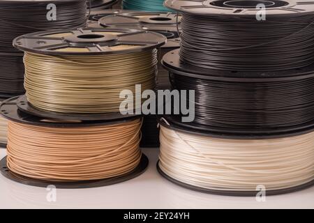Many PLA and ABS filament spools for 3D printer. Stock Photo