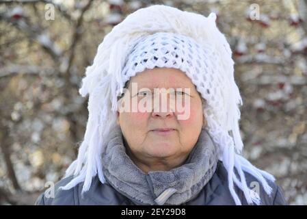 Elderly woman in  white knitted shawl on her head is about Rowan Stock Photo