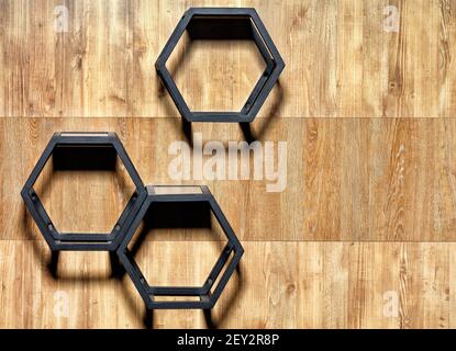 Metal black cubic stylish shelves with hex cutouts on a wooden wall background, copy space. Stock Photo