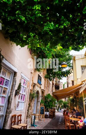 Vine covered cobblestone outdoor Greek cafe in Chania on Crete, the largest of the Greek Islands. Stock Photo