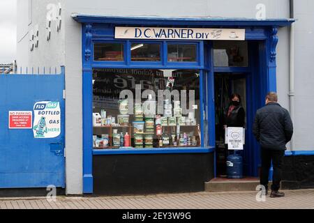 Ibstock, Leicestershire, UK. 5th March 2021. A hardware shop keeper speaks to a customer. North West Leicestershire has the highest coronavirus rate in England according to the latest Public Health England figures. Credit Darren Staples/Alamy Live News.