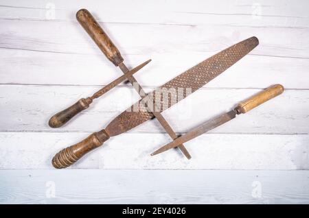 Sets of different wood rasps of different sizes in the middle of an old wooden floor background. top view. Stock Photo