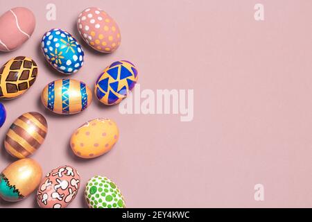 A gentle festive banner colored Easter eggs on a light pink background with room for text to copy the space. Options for coloring eggs for Easter Stock Photo