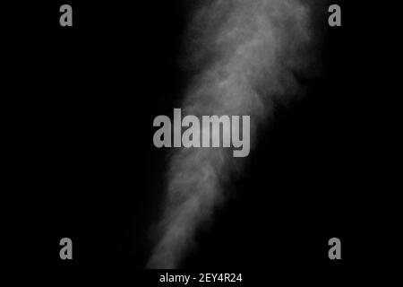 Abstract steam with dots of spray moves on a black background. Figured smoke can be used for design. Stock Photo