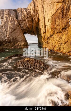 Bwa Gwyn sea arch near Rhoscolyn, Anglesey, North Wales Stock Photo