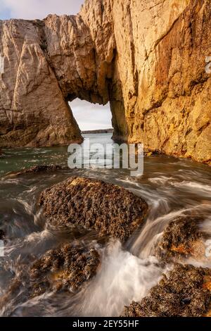 Bwa Gwyn sea arch near Rhoscolyn, Anglesey, North Wales Stock Photo