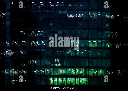 End of working day in glass office building with numerous offices with glass walls and windows. High quality photo Stock Photo
