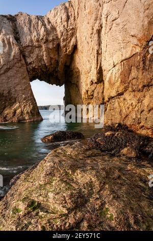 Bwa Gwyn sea arch near Rhoscolyn, Anglesey, North Wales Stock Photo