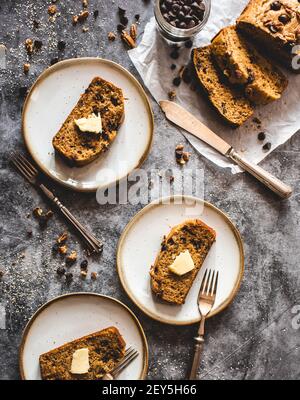 Top view of sliced banana bread on plates on a gray background. Stock Photo