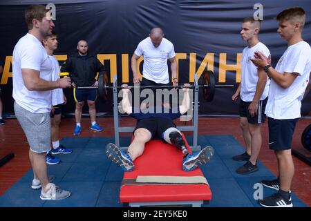 Male disabled athlete lifting barbell in a gym. Kiev, Ukraine. October 25, 2018 Stock Photo