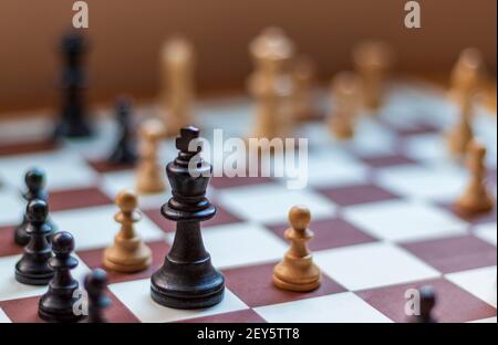 Wooden chess pieces in the foreground Stock Photo