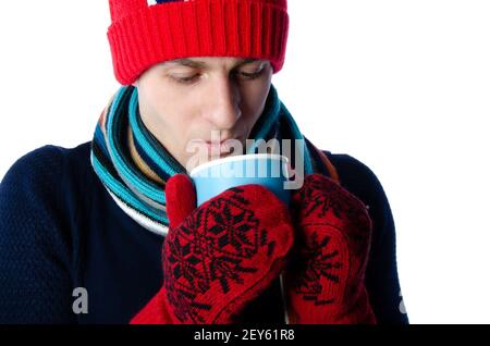Young attractive guy is drinking a hot drink. Stock Photo