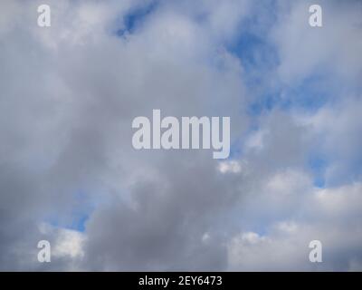 Stratus clouds, cirrus light above and cumulonimbus dark below, cloudscape Stock Photo