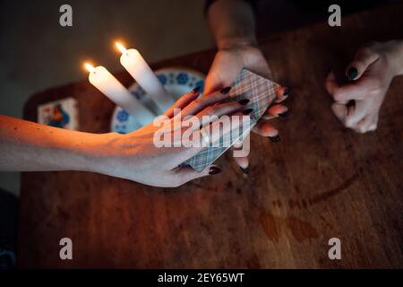 choose a card from the hands of a fortune teller. a woman tells fortunes during a magical ritual. belief in mysticism