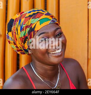 Happy African woman in the small village of Keta located in Ghana, dressed in African headdress Stock Photo