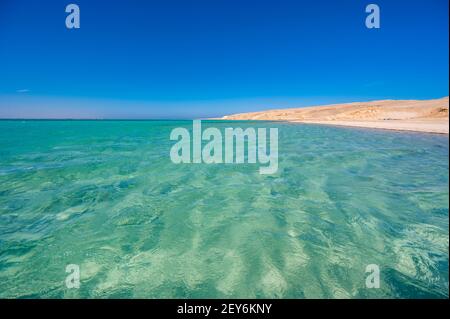 Orange Bay with white beach and crystal clear azure water - paradise coastline of Giftun island, Mahmya, Hurghada, Red Sea, Egypt Stock Photo