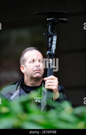 A police officer films the scene as hundreds of protesters demonstrate in downtown Portland, Ore., on December, 6 2014. Organized by Don't Shoot Portland, the peaceful demonstration called for charges to be brought against officer Darren Wilson for the shooting of Michael Brown in Ferguson, Mo., and officer Daniel Pantaleo for the chokehold that led to the death of Eric Garner in New York City. (Photo by: Alex Milan Tracy/Sipa USA)