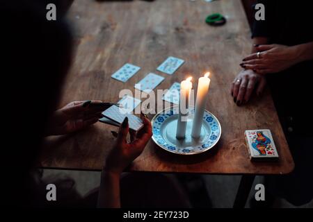 choose a card from the hands of a fortune teller. a woman tells fortunes during a magical ritual. belief in mysticism