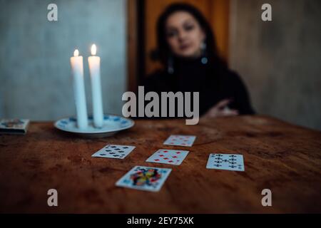 choose a card from the hands of a fortune teller. a woman tells fortunes during a magical ritual. belief in mysticism