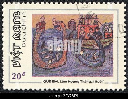 Postage stamp. Fishermen in the sea, from series Picture painted by a child, Vietnam, circa 1984 Stock Photo