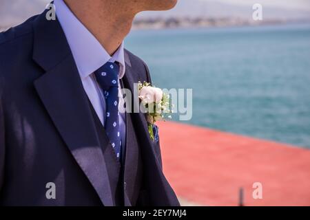 Morning groom, Groom in a jacket, The groom straightens the buttonhole, wedding day. Wedding. Details Stock Photo