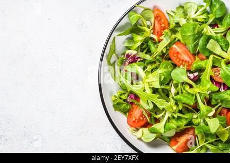 Green salad with arugula, lamb and tomatoes. Stock Photo