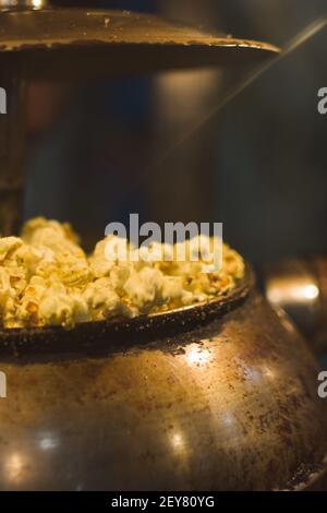 Close up of popcorn being made in a machine in a theatre Stock Photo