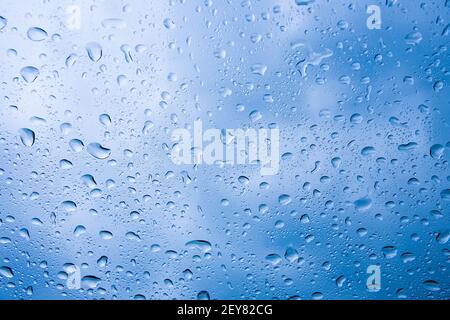 water drops on car windshield reflecting the sky Stock Photo