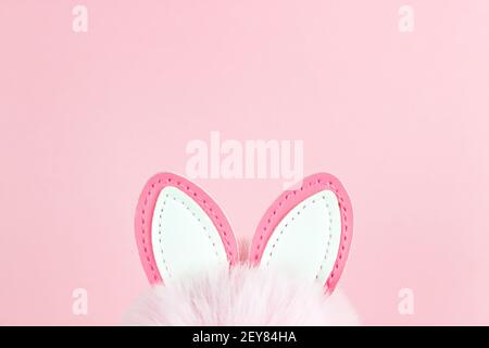 Easter background. Ears of an Easter bunny on pink background. Spring holiday celebration photo design template Stock Photo