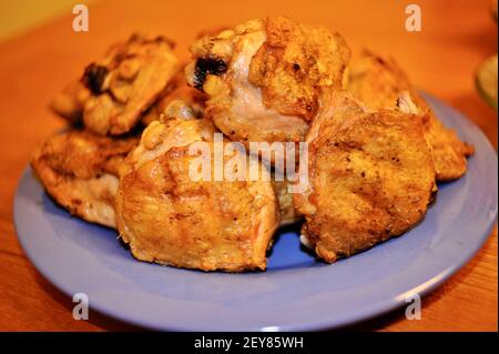 A plated of delicious freshly grilled, golden-brown, cooked marinaded chicken on an outdoor barbecue gas grill, California, USA Stock Photo