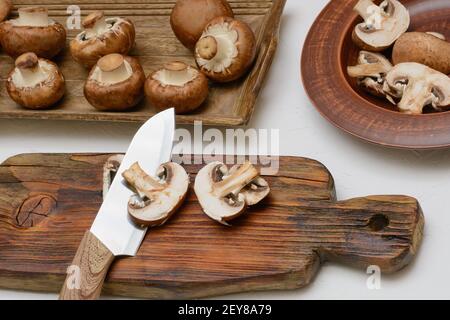 Brown royal champignons. Slicing mushrooms for cooking. Stock Photo