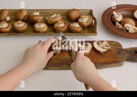 Slicing large royal champignons. Mushrooms in cooking process. Stock Photo