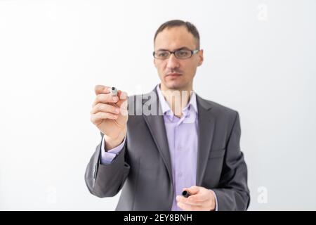 male writing something on glass board with marker Stock Photo