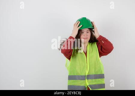 Image of a young cute girl standing in vest and wearing a crash helmet Stock Photo