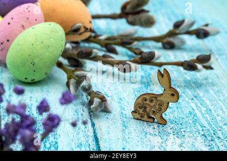 The Easter bunny. Happy Easter. Easter eggs. Willow twigs. Holy Easter. Blue background. Stock Photo