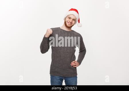 Holiday Concept - Young beard man in sweater showing hand up with exciting feeling. Stock Photo