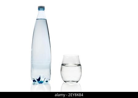 plastic bottle and glass of water with reflection isolated on white background, copy space Stock Photo