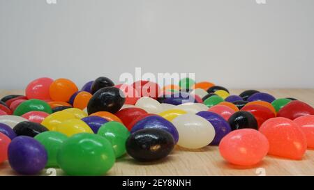 Jelly beans spread out on a table with white space above for copy Stock Photo