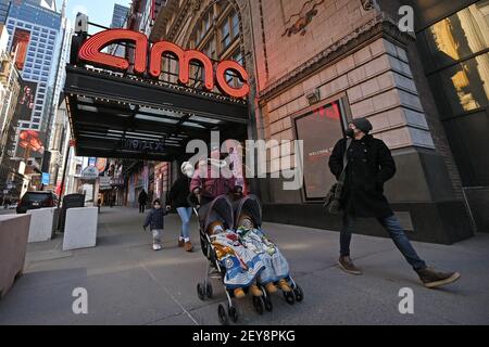 New York, USA. 05th Mar, 2021. People walk past the AMC 42nd Street theater as movie theaters reopen at 25% capacity across the city, New York, NY, March 5, 2021. New York Gov. Andrew Cuomo has said that movie theaters are permitted to reopen on March 5 at 25% capacity, at no more than 50 people per screening. (Photo by Anthony Behar/Sipa USA) Credit: Sipa USA/Alamy Live News Stock Photo